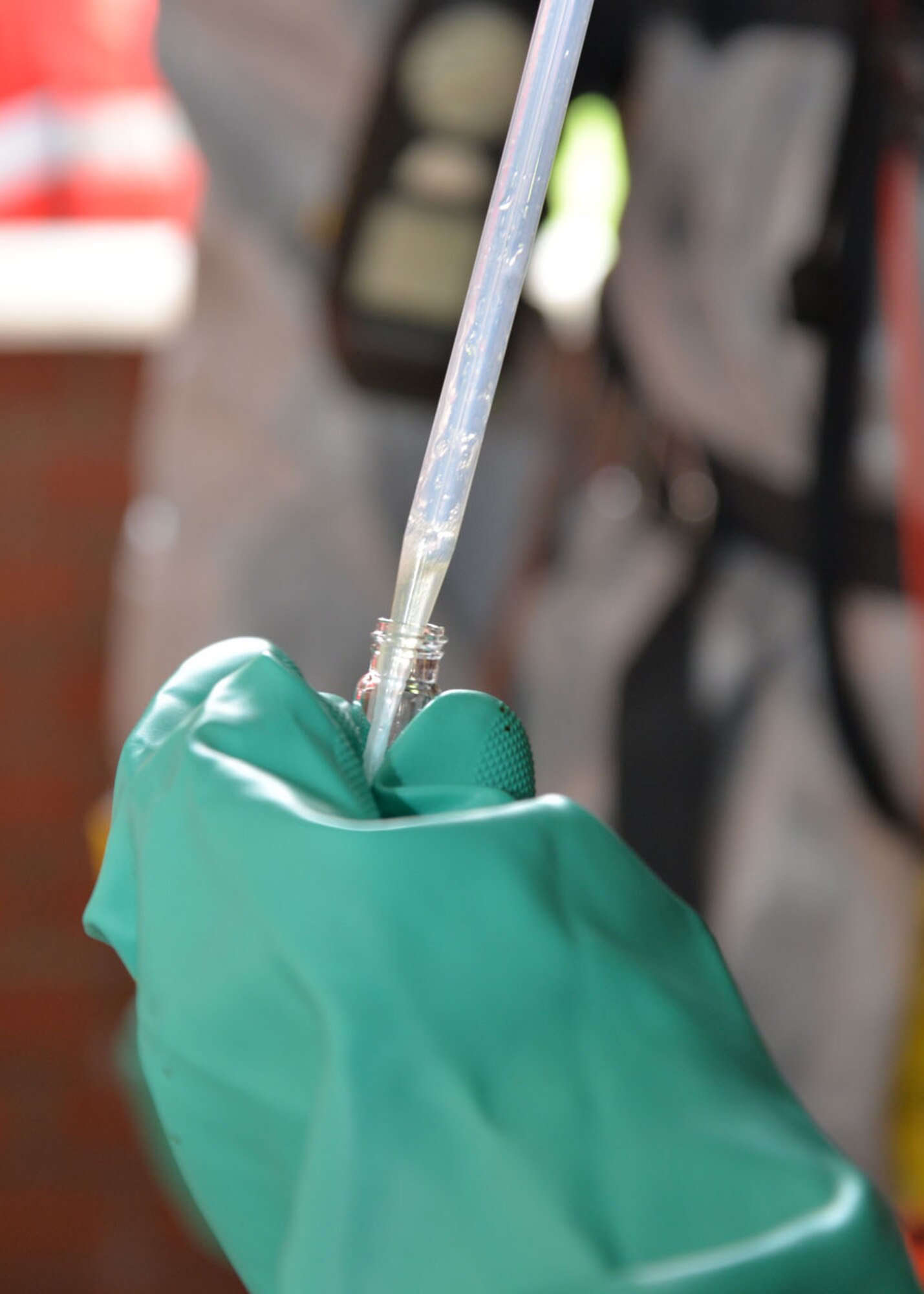 U.S. Air Force Senior Airman Adaina Mendoza, 48th Aerospace Medicine Squadron Bioenvironmental Engineering journeyman, collects a sample of suspected hazardous substance for further testing in a laboratory environment during a joint training exercise Feb. 10, 2016, on RAF Mildenhall, England. Responders from the 100th Civil Engineer Squadron Fire Department, 100th CES Emergency Management flight, 48th CES Emergency Management flight, and 48th AMDS Bioenvironmental Engineering flight joined forces to train on responding to a suspicious package containing hazardous materials. (U.S. Air Force photo by Karen Abeyasekere/Released)