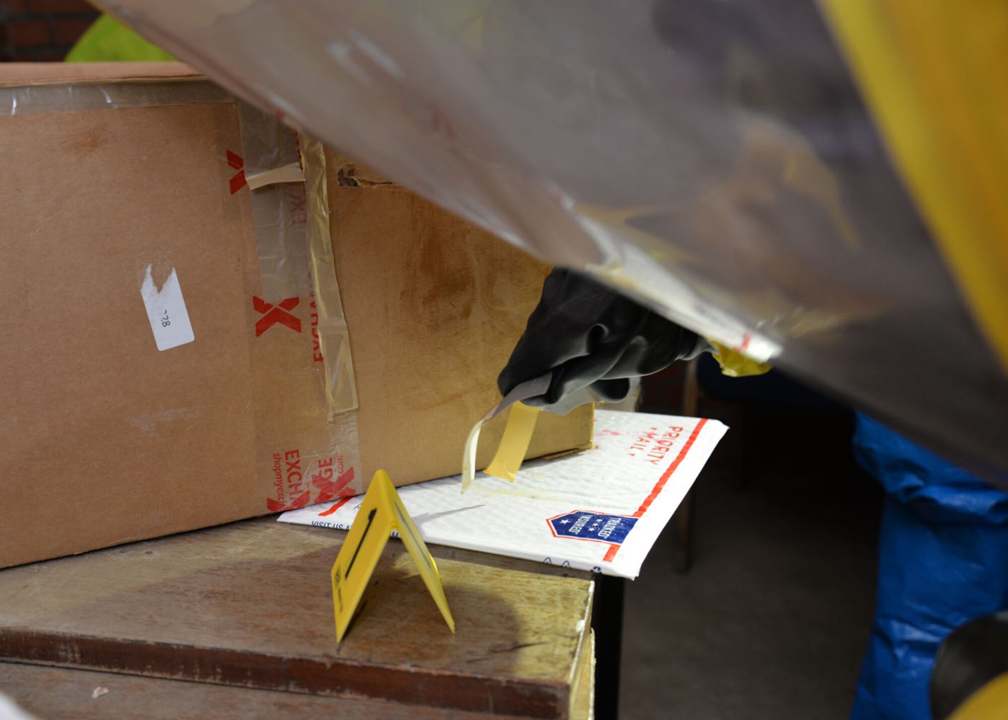 U.S. Air Force Senior Airman Breanna Faulkner, 100th Civil Engineer Squadron Emergency Management journeyman, uses M8 chemical detection paper to test an unknown substance during a joint training exercise Feb. 10, 2016, on RAF Mildenhall, England. The M8 paper can detect the presence of a G- or V-series nerve agent in just seconds by changing colors when it comes in contact with a liquid agent. (U.S. Air Force photo by Karen Abeyasekere/Released)