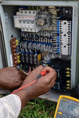 Tech. Sgt. Andre Williams, 644th Combat Communications Squadron heating, ventilation and air conditioning technician, checks the power of an environmental control unit during exercise Cope North 16 Feb. 16, 2016, at Andersen Air Force Base, Guam. The unit provided cooling for military members in the tents and enhanced mission effectiveness. (U.S. Air Force photo/Airman 1st Class Arielle Vasquez)