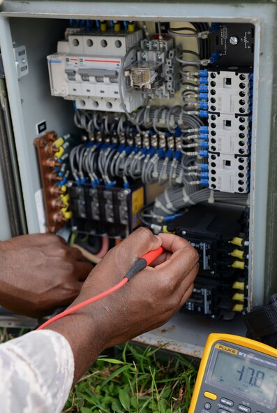 Tech. Sgt. Andre Williams, 644th Combat Communications Squadron heating, ventilation and air conditioning technician, checks the power of an environmental control unit during exercise Cope North 16 Feb. 16, 2016, at Andersen Air Force Base, Guam. The unit provided cooling for military members in the tents and enhanced mission effectiveness. (U.S. Air Force photo/Airman 1st Class Arielle Vasquez)