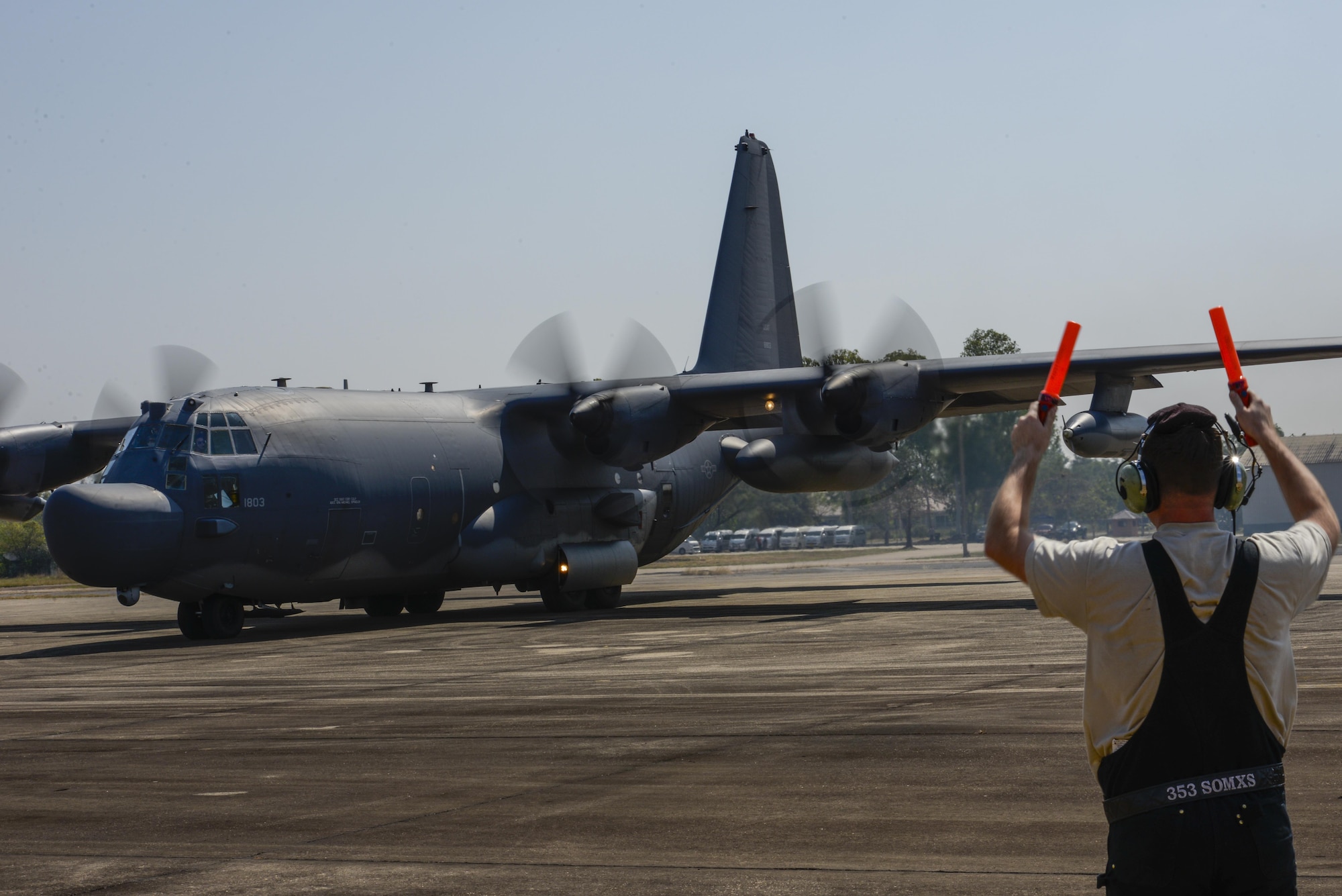 A member of the 353rd Special Operations Maintenance Squadron marshals an MC-130H from the 1st Special Operations Squadron during exercise Cobra Gold in Udon Thani, Thailand, Feb. 8, 2016. Cobra Gold 16 increases cooperation, interoperability and collaboration among partner nations in order to achieve effective solutions to common challenges.   (U.S. Air Force photo by Senior Airman Stephen G. Eigel)
