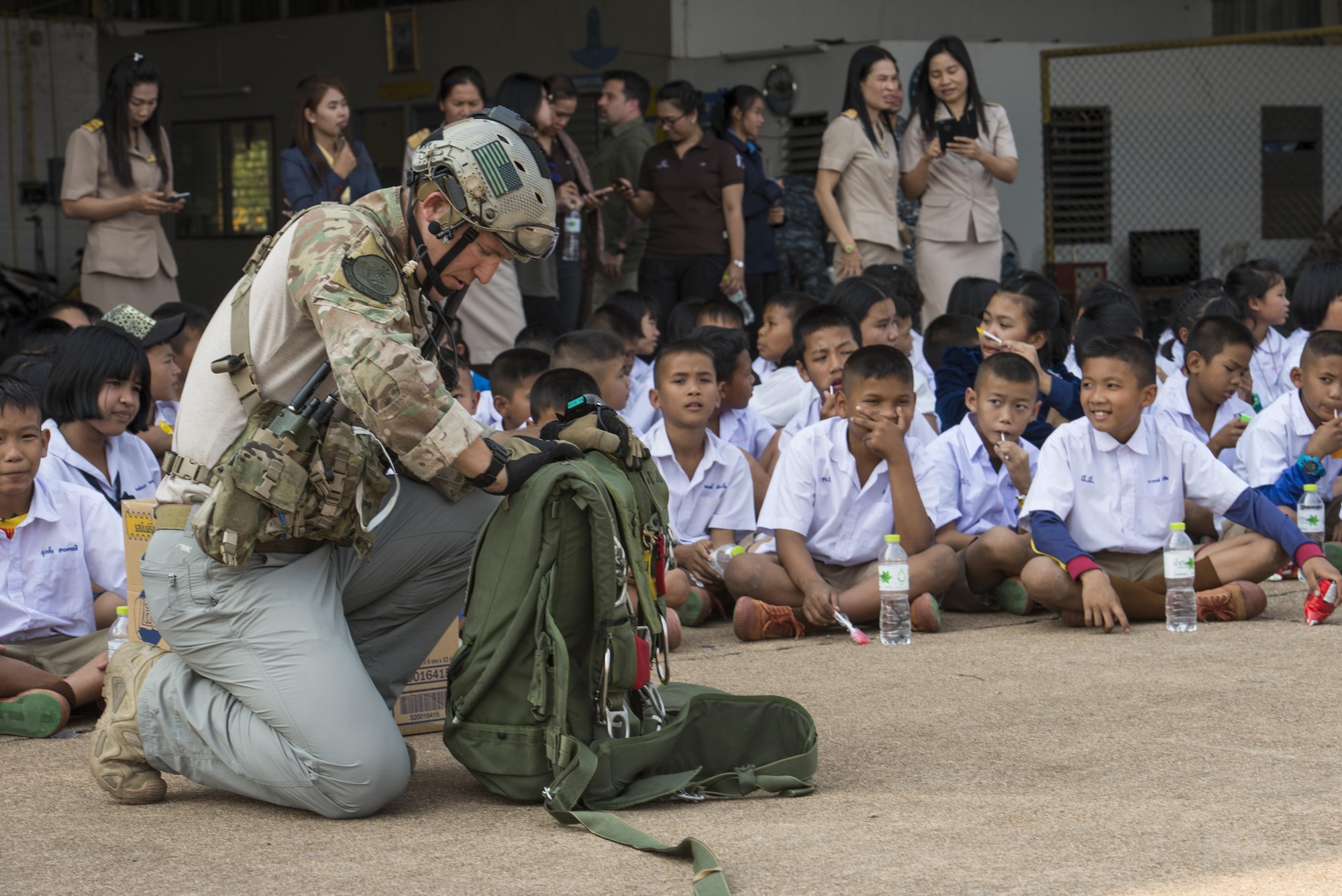 A member of the 320th Special Tactics Squadron prepares his parachute for a jump from a MC-130H during a community relations event at Cobra Gold 16, Nam Phong, Thailand, Feb. 15, 2016. The students were invited to watch different aspects of the 320th STS job roles such as jumping out of aircraft and controling airspace. (U.S. Air Force photo by Senior Airman Stephen G. Eigel)

