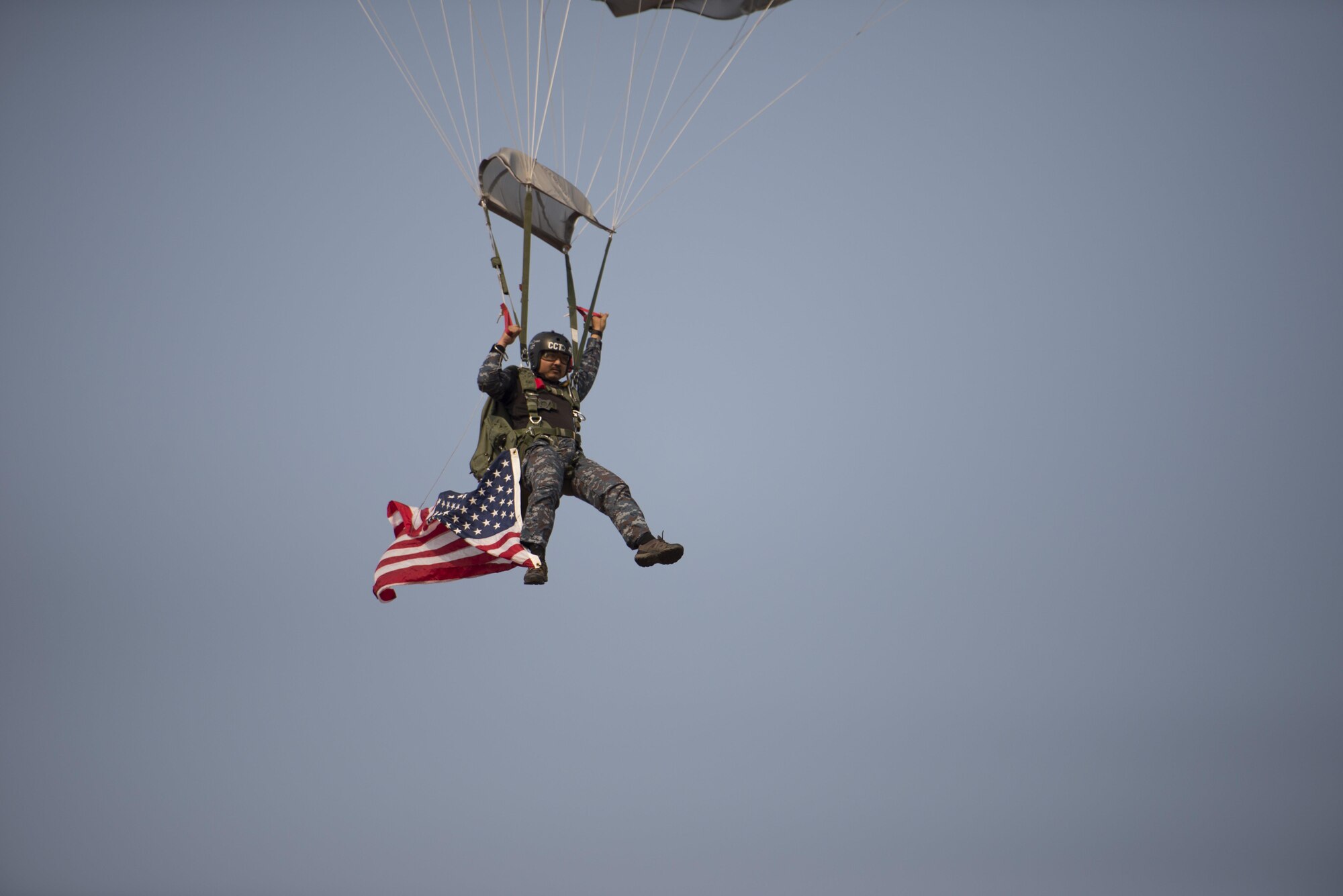 A member of the Thailand Royal Air Force parachutes into the drop zone with an American flag during a community relations event at Cobra Gold 16, Nam Phong, Thailand, Feb. 15, 2016. Cobra Gold 16 is a Thai-U.S. co-sponsored exercise that represents the longstanding friendship between the Thai and American peoples. (U.S. Air Force photo by Senior Airman Stephen G. Eigel)