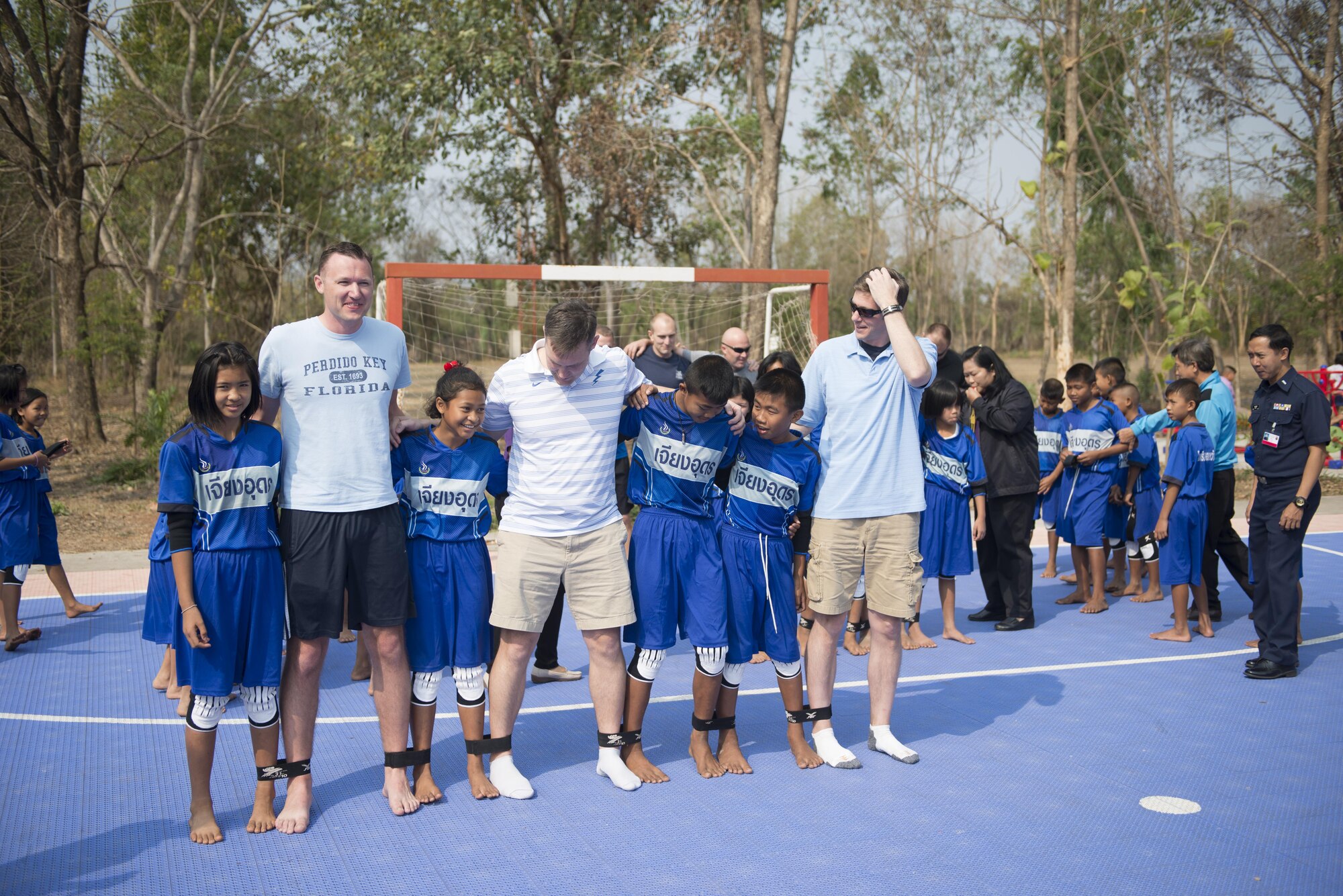 Members of the 353rd Special Operations Group participate in an eight legged race with students from Nong-no Wittayakan school during exercise Cobra Gold 16, Udon Thani, Thailand, Feb. 16, 2016. Members of the 353rd SOG spent the day playing a multitude of different games with the children from Nong-no Wittayakan school. (U.S. Air Force photo by Senior Airman Stephen G. Eigel)
