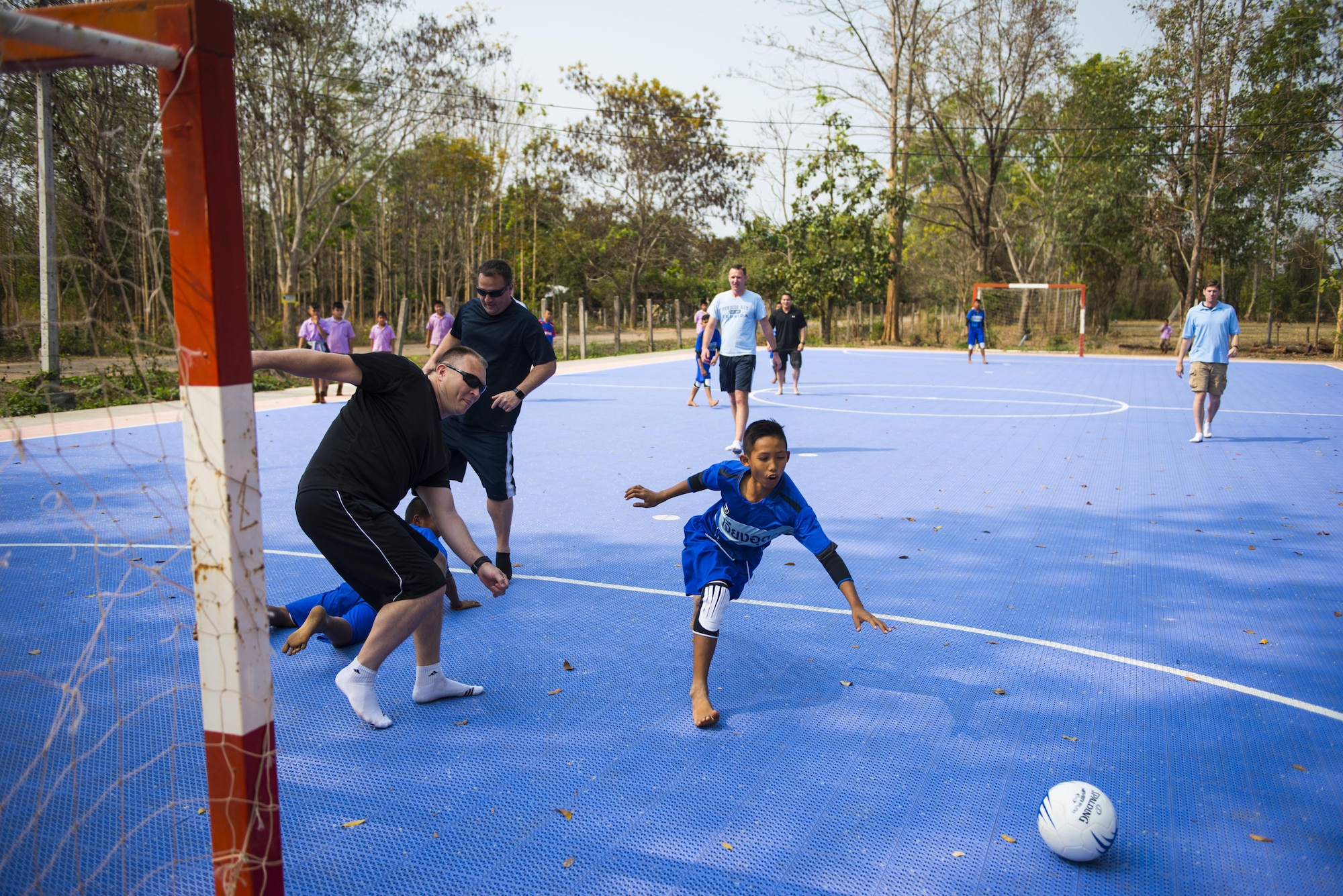 Members of the 353rd Special Operations Group play futsal with students from Nong-no Wittayakan school during exercise Cobra Gold 16, Udon Thani, Thailand, Feb. 16, 2016. Cobra gold 16 included an increased focus on Humanitarian Civic Action, community engagement, and medical activities conducted during the exercise to support the needs and humanitarian interests of civilian populations around the region. (U.S. Air Force photo by Senior Airman Stephen G. Eigel)