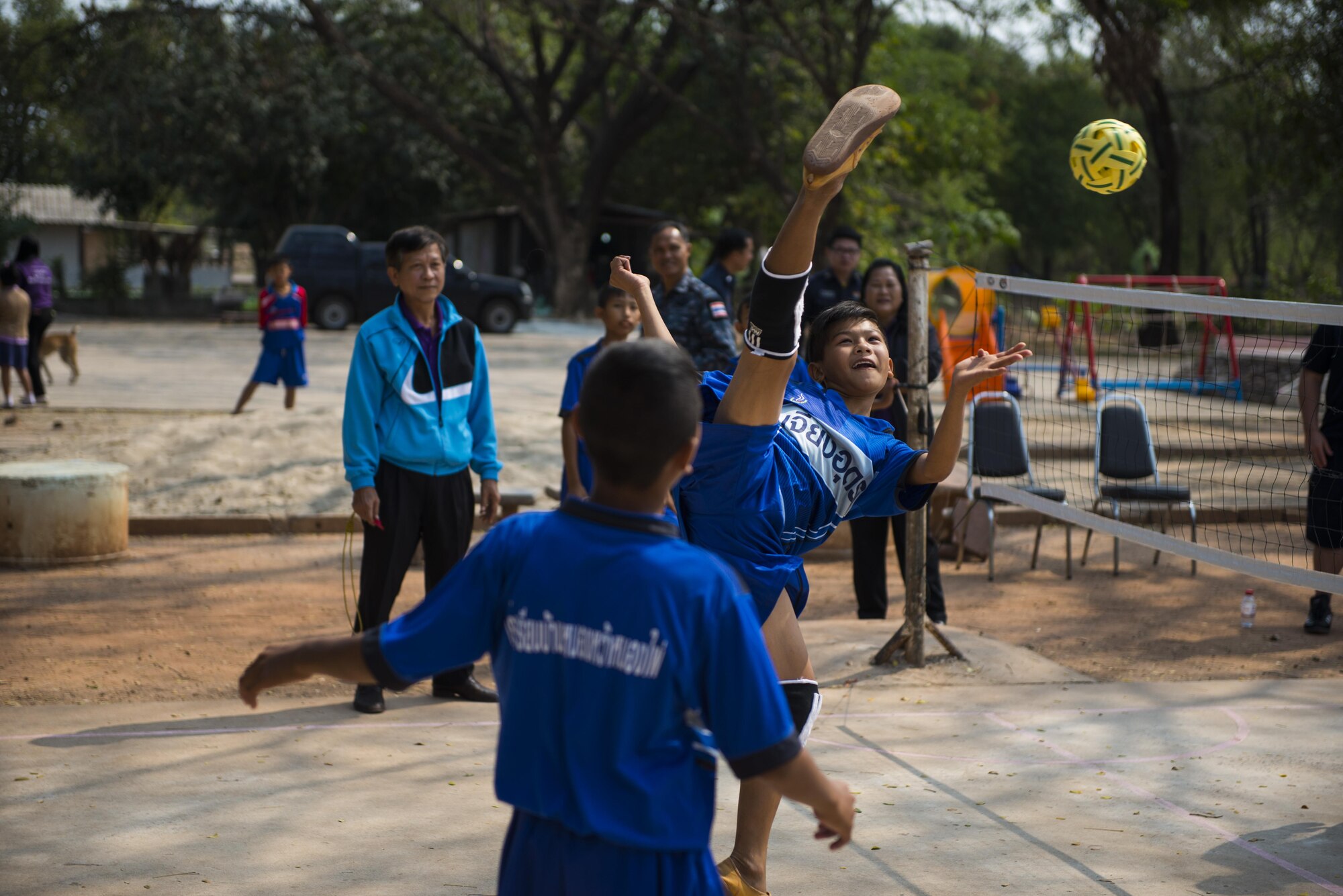Members of the 353rd Special Operations Group play a game called Tak Tak with students from Nong-no Wittayakan school during exercise Cobra Gold 16, Udon Thani, Thailand, Feb. 16, 2016. Humanitarian Civic Action programs conducted during CG16 demonstrate a mutual commitment to support security and humanitarian interests of friends and partner nations. The programs will improve the quality of life, as well as the general health and welfare of civilian residents in the exercise areas. (U.S. Air Force photo by Senior Airman Stephen G. Eigel)