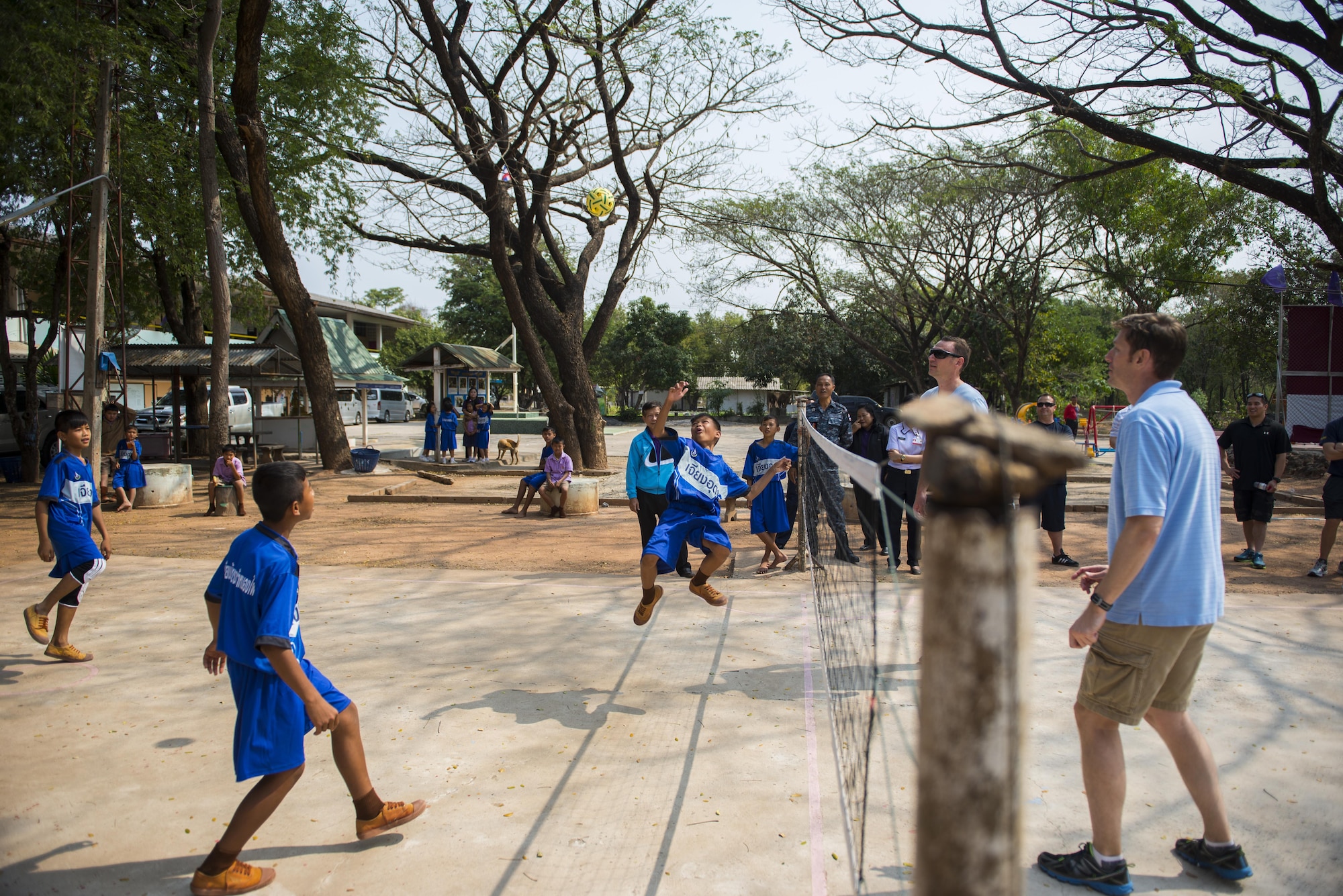 Members of the 353rd Special Operations Group play a game called Tak Tak with students from Nong-no Wittayakan school during exercise Cobra Gold 16, Udon Thani, Thailand, Feb. 16, 2016. Cobra gold 16 included an increased focus on Humanitarian Civic Action, community engagement, and medical activities conducted during the exercise to support the needs and humanitarian interests of civilian populations around the region. (U.S. Air Force photo by Senior Airman Stephen G. Eigel)