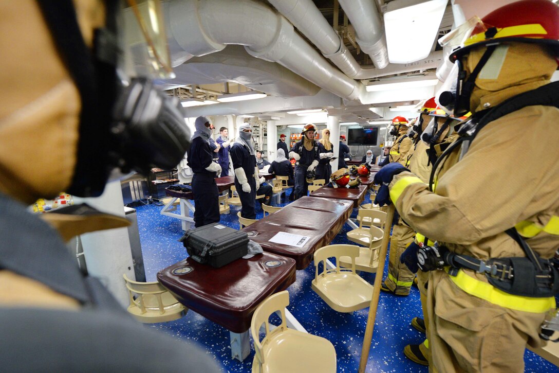 Sailors receive a mission and safety brief before participating in a fire drill aboard the USS Ross in the Mediterranean Sea, Feb. 19, 2016. The Ross, an Arleigh Burke-class guided-missile destroyer, forward deployed to Rota, Spain, is conducting a routine patrol in the U.S. 6th Fleet area of operations in support of U.S. national security interests in Europe. Navy photo by Petty Officer 2nd Class Justin Stumberg