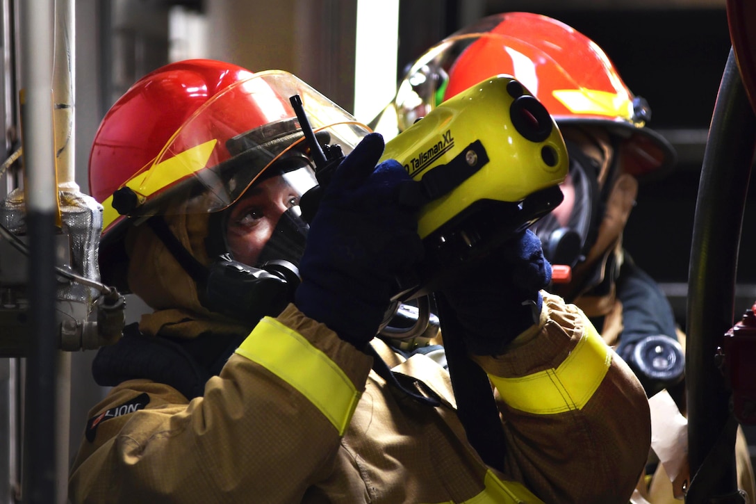 Navy Petty Officer 2nd Class Rafael Orellana, foreground, uses a naval firefighting thermal imager during a fire drill aboard the USS Ross in the Mediterranean Sea, Feb. 19, 2016. Orellana is a logistics specialist. Navy photo by Petty Officer 2nd Class Justin Stumberg