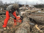 Virginia National Guard Soldiers assigned to the Powhatan-based 180th Engineer Company, 276th Engineer Battalion, 91st Troop Command clear debris to open a blocked road Feb. 25, 2016, in Essex County, Virginia. More than 40 Virginia National Guard Soldiers are on state active duty assisting a multi-agency effort with clean up operations in Essex, Sussex, Patrick and Westmoreland Counties. 