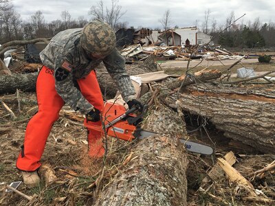 Virginia National Guard Soldiers assigned to the Powhatan-based 180th Engineer Company, 276th Engineer Battalion, 91st Troop Command clear debris to open a blocked road Feb. 25, 2016, in Essex County, Virginia. More than 40 Virginia National Guard Soldiers are on state active duty assisting a multi-agency effort with clean up operations in Essex, Sussex, Patrick and Westmoreland Counties. 