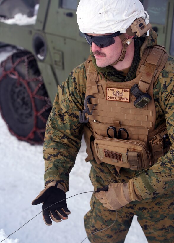 Sgt. Derek Turner, an Explosive Ordnance Disposal technician 2nd EOD Company, Combat Logistics Battalion 252, reels in detonation cord after detonating a controlled explosion in Rena, Norway, Feb. 22, 2016, in preparation for Exercise Cold Response 16. The exercise will include 12 NATO allies and partner nations, and approximately 16,000 troops. Marines will train alongside the Norwegian EOD to see how they operate in order to become more proficient at working with each other in the future.