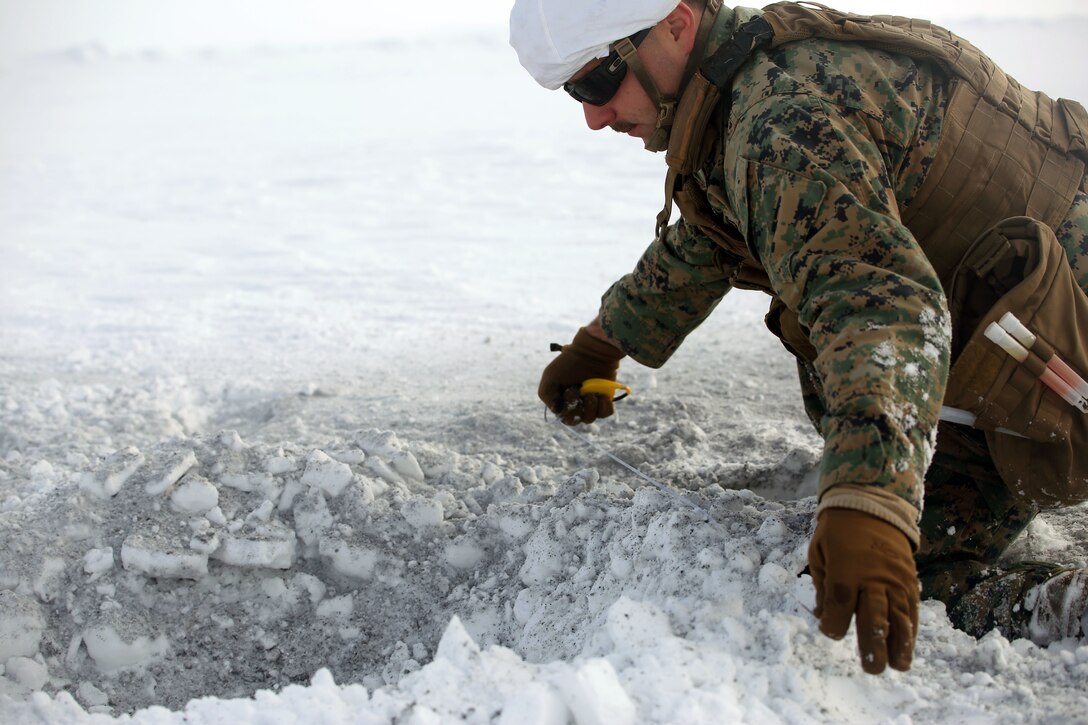 Staff Sgt. Keith Winkeleer, an Explosive Ordnance Disposal technician with 2nd EOD Company, Combat Logistics Battalion 252, measures the depth and width of a crater caused by a C-4 explosion in Rena, Norway, Feb. 22, 2016, in preparation for Exercise Cold Response 16. The exercise will include 12 NATO allies and partner nations, and approximately 16,000 troops. Marines will train alongside Norwegian EOD specialists to see how they operate in order to become more proficient at working with each other in the future.