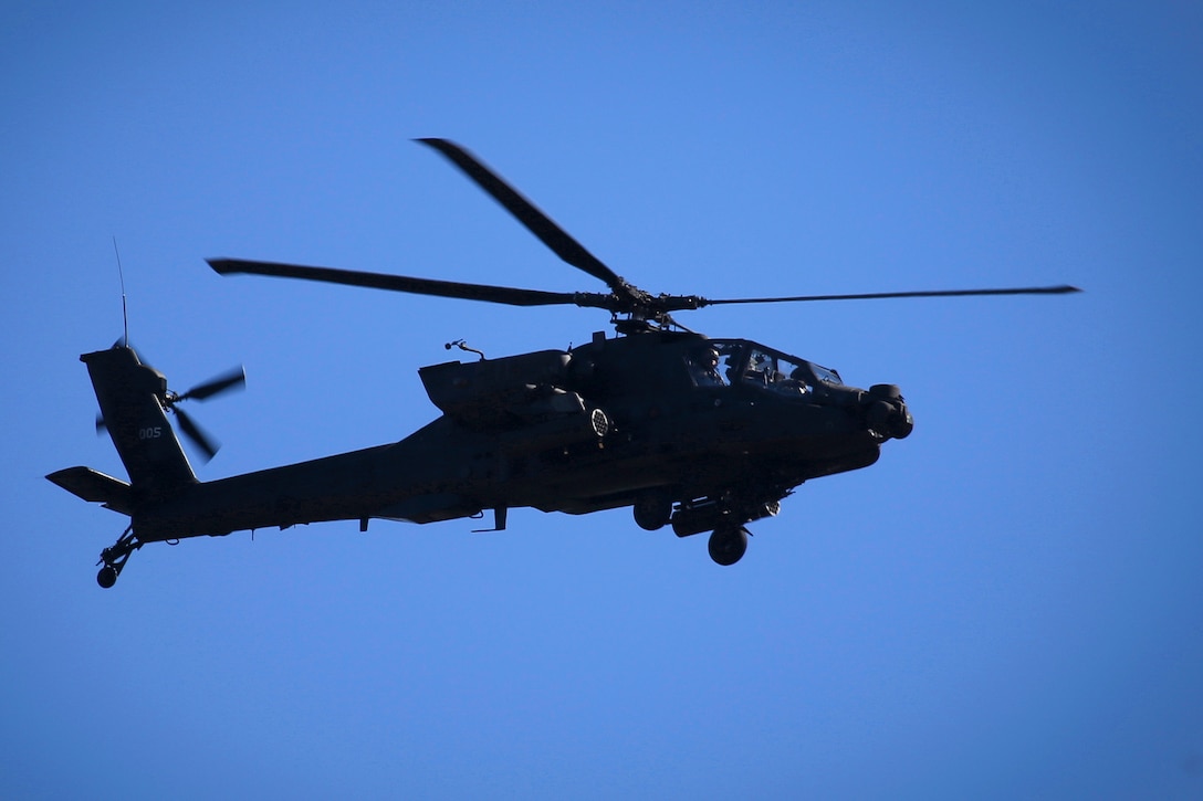 An AH-64D Apache helicopter flies support coverage for soldiers and airmen participating in Exercise Eagle Eye over Warren Grove Gunnery Range, N.J., Feb. 18, 2016. The helicopter crew is assigned to the Pennsylvania Army National Guard's 1-104th Attack Reconnaissance Battalion, the airmen are assigned to the 227th Air Support Operation Squadron, and the soldiers are assigned to the 19th Special Forces Group. New Jersey Air National Guard photo by Tech. Sgt. Matt Hecht
