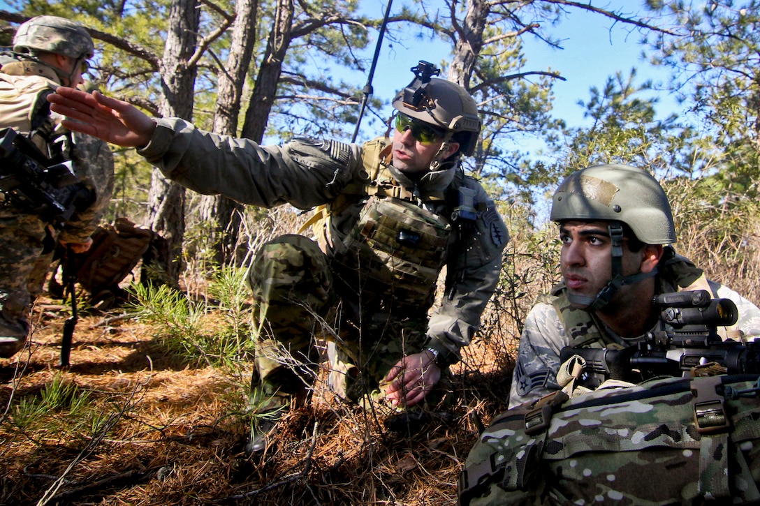 A Green Beret, left, left, advises Air Force Senior Airman Bernabé Agüero on fields of fire during Exercise Eagle Eye at Warren Grove Gunnery Range, N.J., Feb. 18, 2016. Agüero is assigned to the 227th Air Support Operation Squadron. New Jersey Air National Guard photo by Tech. Sgt. Matt Hecht