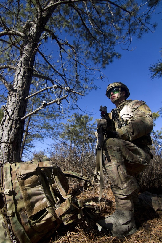 Air Force Senior Airman Josh Derins takes a knee while providing security at an observation post during Exercise Eagle Eye at Warren Grove Gunnery Range, N.J., Feb. 18, 2016. Derins is a tactical air control party airman assigned to the 227th Air Support Operation Squadron. New Jersey Air National Guard photo by Tech. Sgt. Matt Hecht