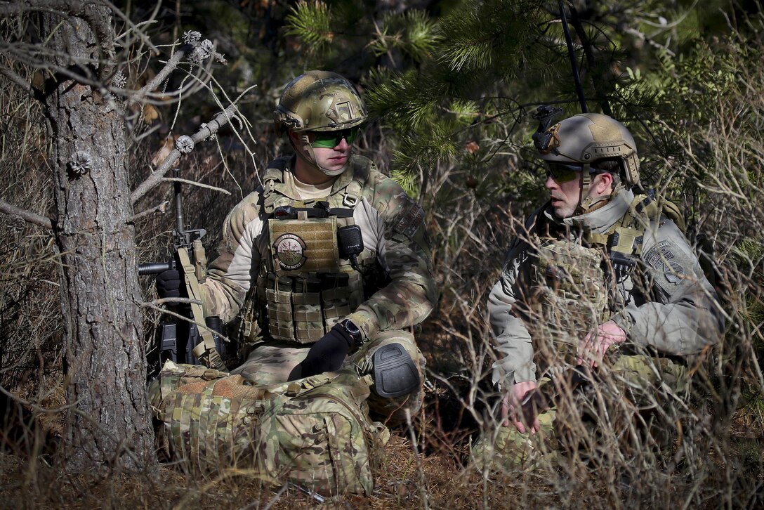 A Green Beret, right, advises Air Force Senior Airman Josh Derins on securing an observation post during Exercise Eagle Eye at Warren Grove Gunnery Range, N.J., Feb. 18, 2016. Derins is a tactical air control party airman assigned to the 227th Air Support Operation Squadron. New Jersey Air National Guard photo by Tech. Sgt. Matt Hecht