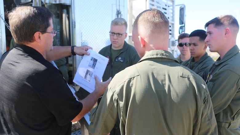 Greg Hudson, Mobile Aircraft Fire Training Device program manager and an Orlando, Florida, native, reviews testable material on operating the Mobile Aircraft Fire Training Device with the Aircraft Rescue and Firefighting Marines aboard Marine Corps Air Station Miramar, California, Feb. 24. The MAFTD is used by ARFF to conduct live-fire training. 