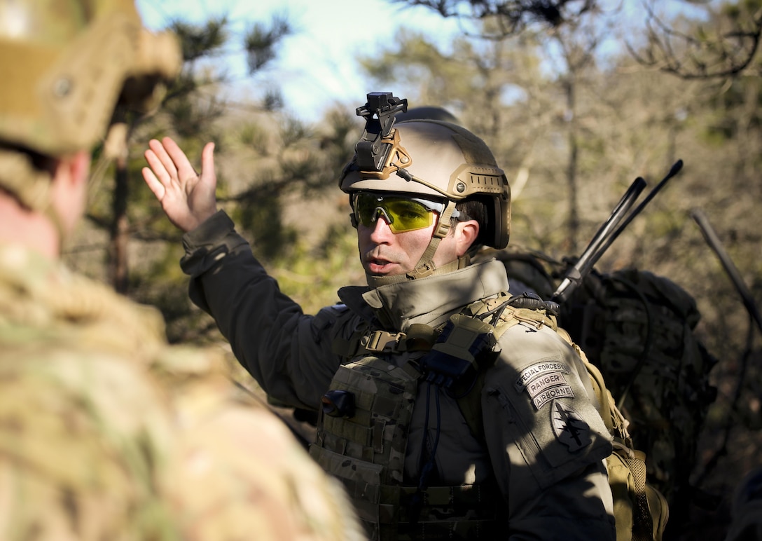 A Green Beret, right, gives patrol tips to airmen during Exercise Eagle Eye at Warren Grove Gunnery Range, N.J., Feb. 18, 2016. New Jersey Air National Guard photo by Tech. Sgt. Matt Hecht