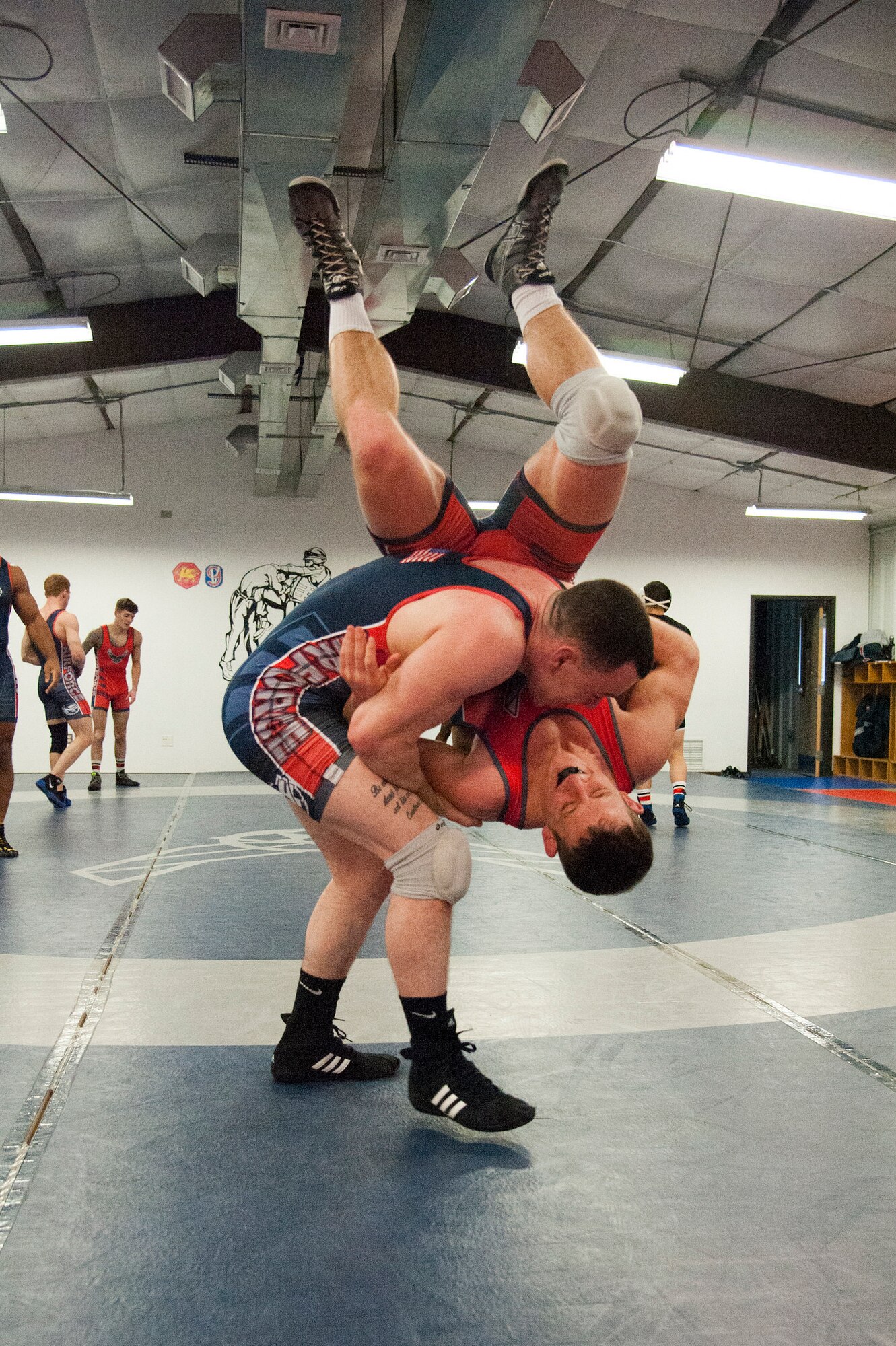 Airman 1st Class Tyler Westlund, from Wright-Patterson Air Force Base, Ohio, takes 1st Lt. Brandon Mueller, from Kirtland AFB, N.M., to the mat during their six-week training camp at Joint Base McGuire-Dix-Lakehurst, N.J. (U.S. Air Force photo/Christian DeLuca)