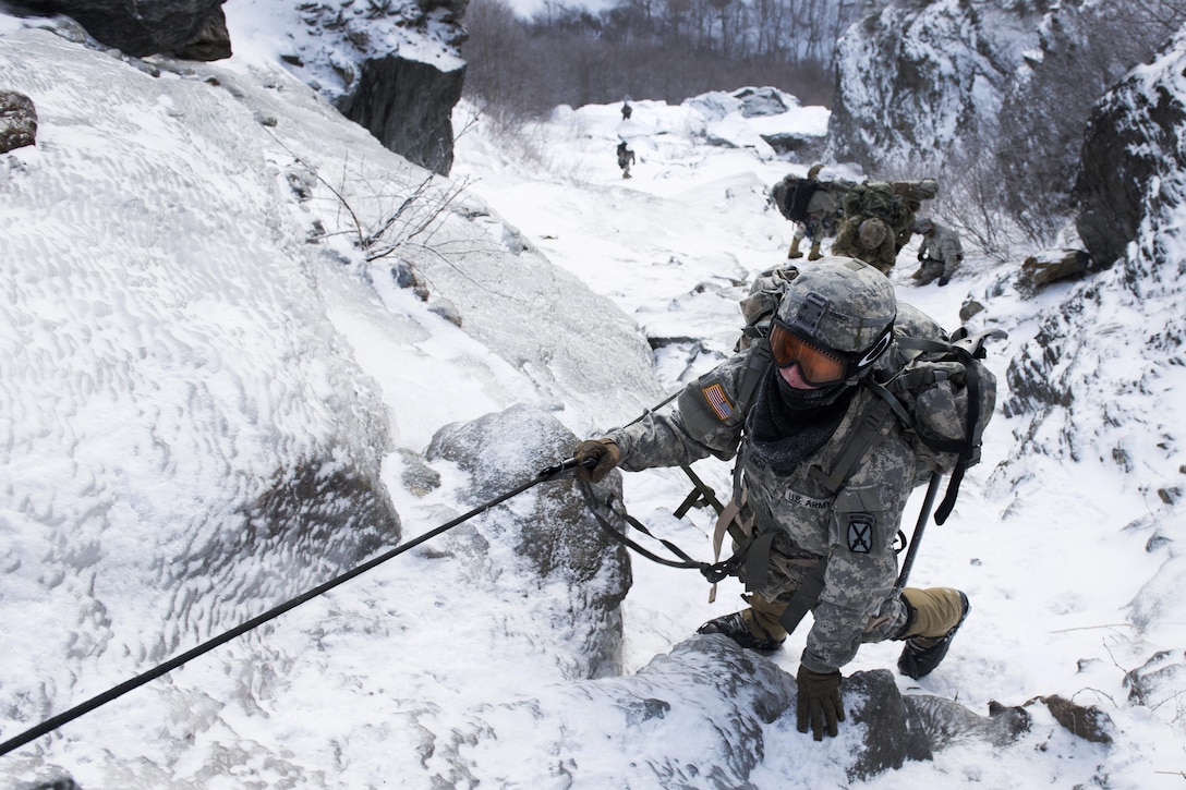 Army Pfc. Olivia French climbs upward at Smugglers’ Notch in Jeffersonville, Vt., Feb. 18, 2016. French, a medic assigned to the 10th Mountain Division’s 7th Engineer Battalion, was participating in mountain warfare training. Vermont Army National Guard photo by Staff Sgt. Nathan Rivard