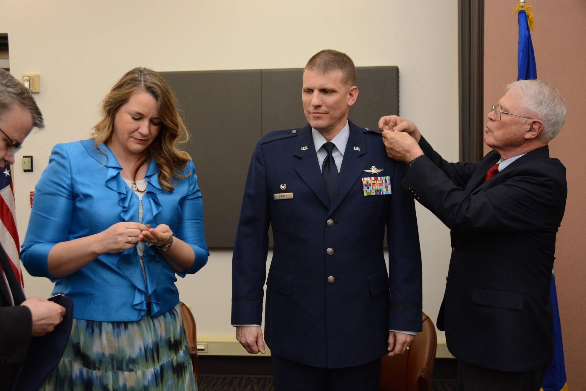 Col. David W. Enfield, 349th Mission Support Group commander, pins on the rank of colonel during a ceremony Feb. 20, 2016 at the Aerial Port Building on Travis Air Force Base. Enfield’s wife, Kathryn and his father, Michael, pinned his new rank on his uniform. 