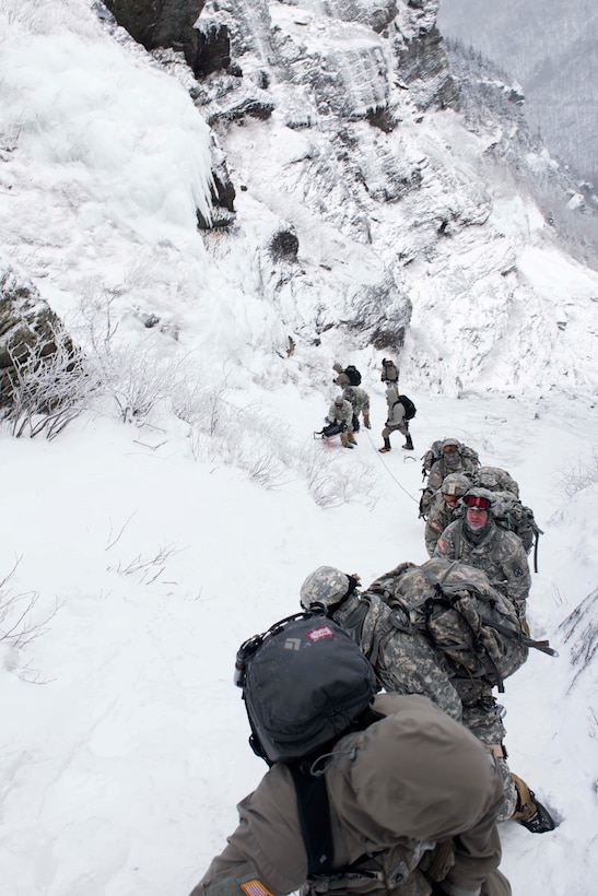 Soldiers participating in the Mountain Warfare Basic Course climb upward at Smugglers’ Notch in Jeffersonville, Vt., Feb. 18, 2016. The Mountain Walk is a culminating event for basic and advanced mountain warfare students to use skills taught at the Mountain Warfare School. U.S. Army National Guard Photo by Staff Sgt. Nathan Rivard
