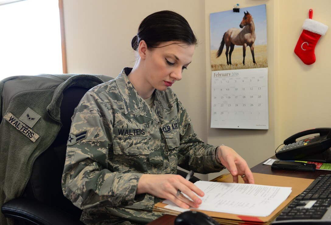 U.S. Air Force Airman 1st Class Chelsea Walters, a 354th Force Support Squadron customer service apprentice, reviews a personnel file, Feb. 25, 2016, at Eielson Air Force Base, Alaska.  Walters works for the Military Personnel Section documenting awards, decorations and in-processing paperwork among other items for Airmen. (U.S. Air Force photo by Airman 1st Class Cassandra Whitman/Released)