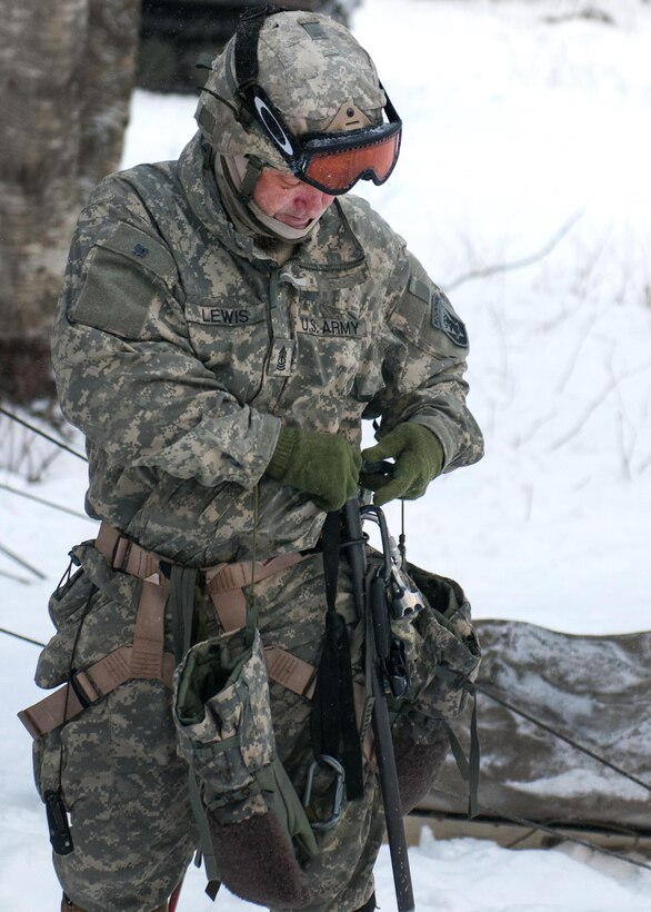 Army 1st Sgt. Corey Lewis prepares his gear before climbing a mountain at Smugglers' Notch, in Jeffersonville, Vt., Feb. 18, 2016. Lewis is assigned to the Connecticut National Guard’s 1st Battalion, 102nd Infantry Regiment, 86th Infantry Brigade Combat Team, Mountain. Vermont Army National Guard photo by Spc. Avery Cunningham