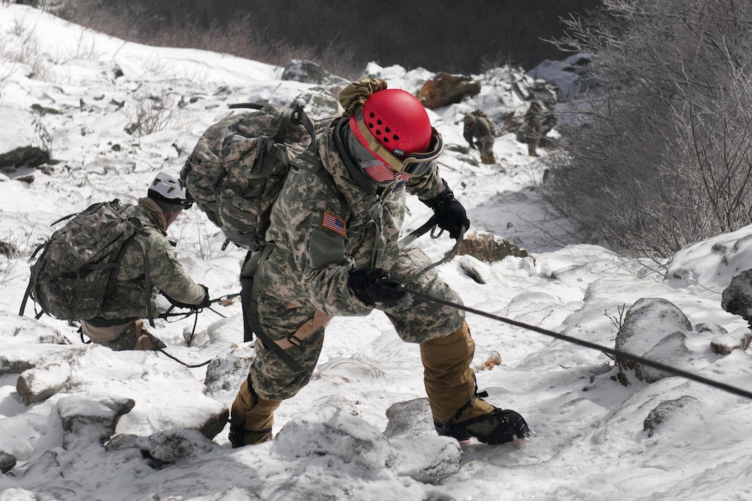 Air Force Maj. Gen. Steven Cray, foreground, the adjutant general of the Vermont National Guard, climbs the mountain at Smugglers' Notch, in Jeffersonville, Vt., Feb. 18, 2016. Cray and other soldiers participated in events for basic and advanced mountain warfare students of the Mountain Warfare School. Vermont Army National Guard photo by Spc. Avery Cunningham