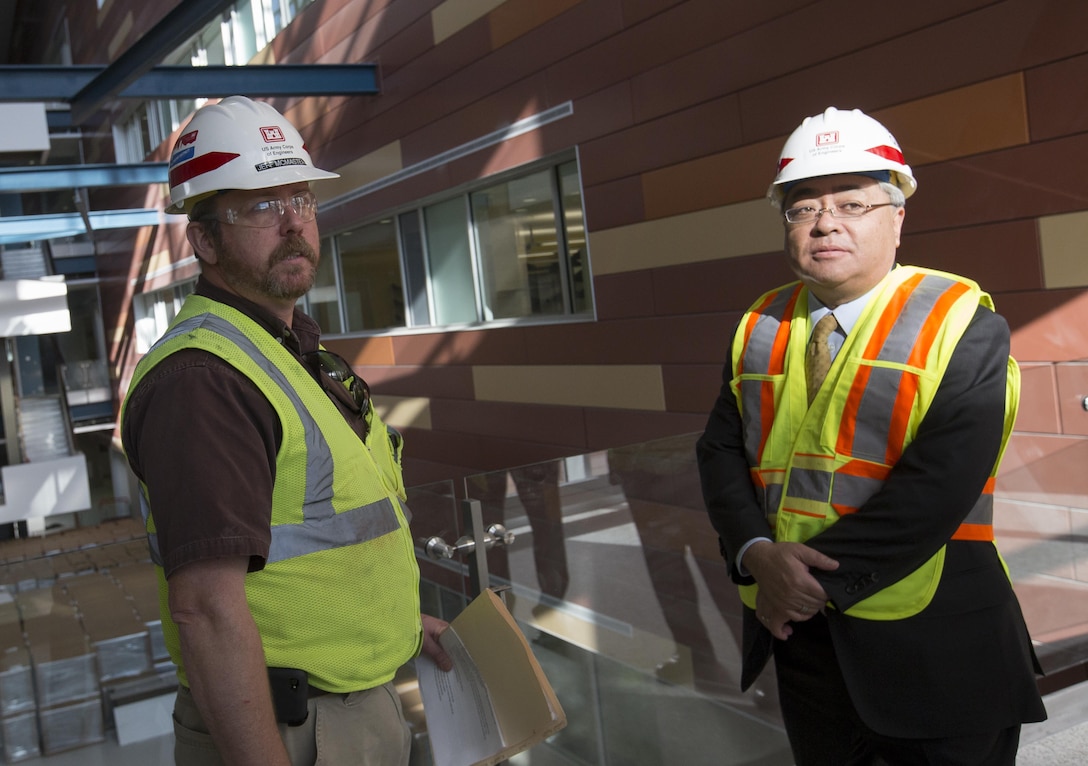 Resident Engineer Jeff McMaster briefs Kazuhiro Watanabe, Japanese Ministry of Defense director general for facilities and installation, on the construction progress at the U.S. Army Medical Research Institute for Infectious Diseases at Fort Detrick on Nov. 18. The two-hour tour moved throughout the huge facility with McMaster highlighting design, materials and construction processes. The seven-person MOD delegation is visiting several Army and Navy military construction projects.