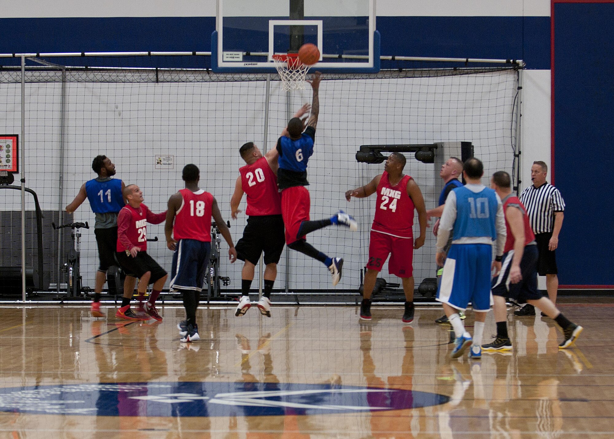 Players from the 90th Maintenance Group Basketball Team and 90th Force Support Squadron Basketball Team player vie for victory during the championship game, Feb. 24, 2016 in the Freedom Hall Fitness Center. The 90th MXG Basketball Team won the 2016 Intramural Basketball Championship. (U.S. Air Force photo by Airman 1st Class Malcolm Mayfield)