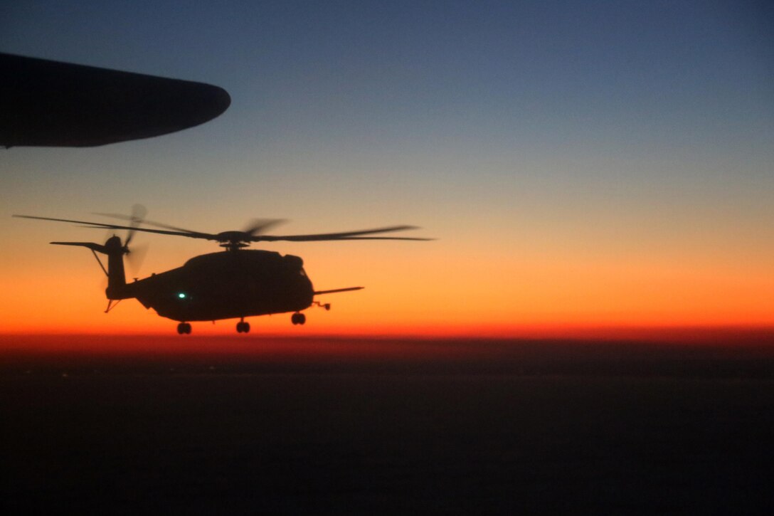A CH-53E Super Stalion flies through the evening sky during an aerial refueling mission over the Atlantic Ocean Feb. 11, 2016. Marine Aerial Refueler Transport Squadron 252 conducted aerial refueling missions off the North Carolina coast to provide routine training for both pilots and crew members. Aerial refueling enables aircraft with short ranges of flight to significantly extend their operational reach. This capability enables missions to be executed more efficiently, which gives the pilots the ability to provide quicker and more extensive support to the Marines on the ground. (U.S. Marine Corps photo by Cpl. N.W. Huertas/Released)