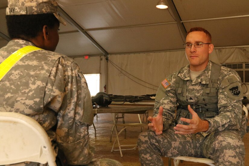 Sgt. Jon Fernandez, a U.S. Army Reserve print journalist attached to the 204th Public Affairs Detachment in Orlando, Fla., interview an Army Reserve food service specialist Feb. 18 for the first Exercise News Day in Fort Polk, La. The exercise tested Reserve public affairs units on their abilities to tell the Army Reserve story in a field environment. (U.S. Army photo by Sgt. Brandon Hubbard, 204th Public Affairs Detachment/Released)