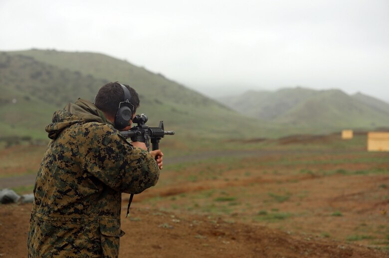 Cpl. Aleksandr Bulymba shoots at the Autonomous Robotic Human Type Target Feb. 18, at Camp Pendleton. The targets have the ability to move through pre-programmed paths and can react to being shot by changing paths, slowing down or speeding up. Bulymba, a Combat Marksmanship coach at Division Schools, 1st Marine Division, is a native of Sacramento. (U.S. Marine Corps Photo by Cpl. John Baker)