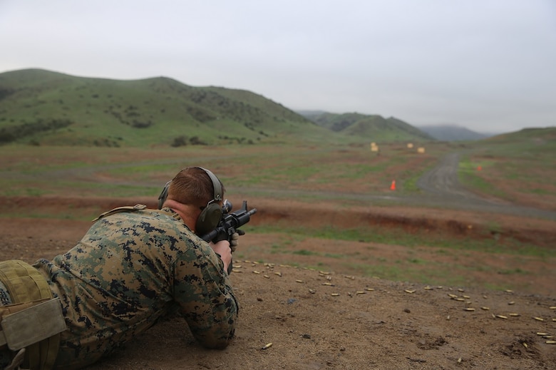 Sgt. Thomas Sereika shoots at the Autonomous Robotic Human Type Target Feb. 18, at Camp Pendleton. By testing these new moving targets from different ranges with a variety of weapons systems, the Marines assess how the targets could improve their training. Sereika is the lead instructor with the Formal Marksmanship Training Center at Division Schools, 1st Marine Division, and is a native of Simi Valley. (U.S. Marine Corps Photo by Cpl. John Baker)