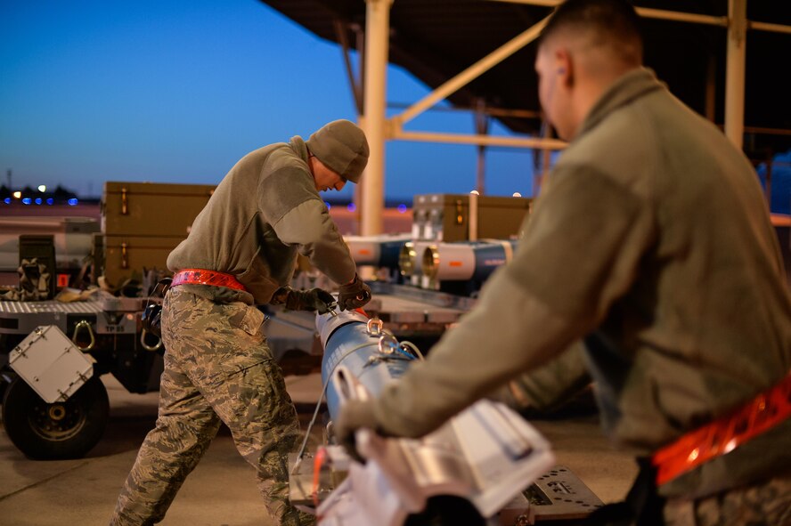 Staff Sgt. Jeffrey Kalsbeek and Airman Juan Rivas, 34th Aircraft Maintenance Squadron load crew members, prepare to equip an F-35A with a GBU-12 laser-guided bomb at Hill Air Force Base, Utah, Feb. 23, 2016. (U.S. Air Force photo by R. Nial Bradshaw)  