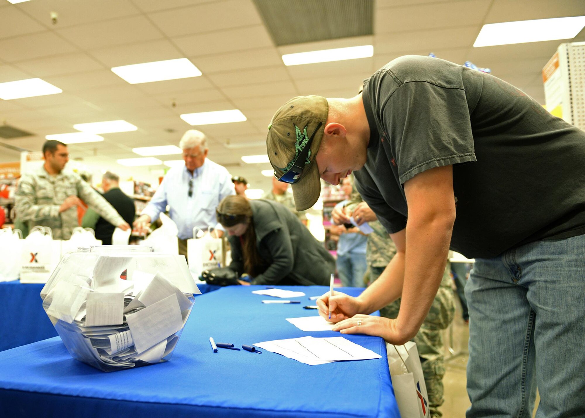 Senior Airman Austin Kauffman enters a raffle during the grand re-opening of the newly renovated Base Exchange Feb. 25, 2016, Beale Air Force Base, California. The remodeling project cost approximate$1.9 million, which includes new flooring, a floor plan to accommodate an expanded product line, new displays, and a new central checkout location. (U.S. Air Force photo by Robert Scott)