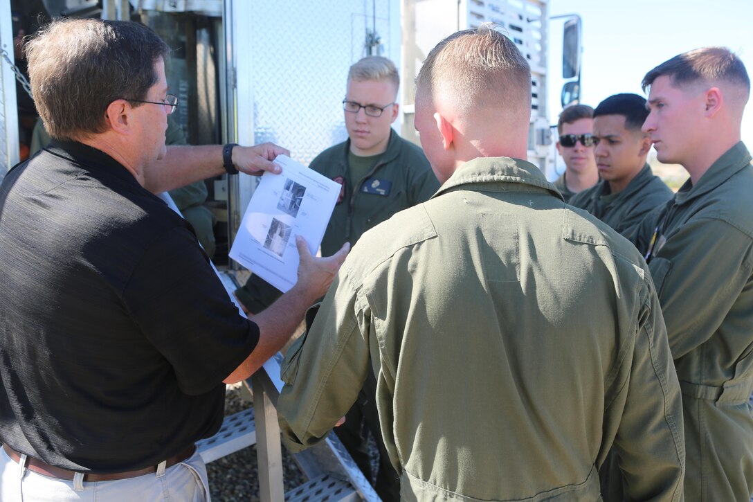 Greg Hudson, Mobile Aircraft Fire Training Device program manager and an Orlando, Fla., native, reviews testable material on operating the Mobile Aircraft Fire Training Device with the Aircraft Rescue and Firefighting Marines aboard Marine Corps Air Station Miramar, Calif., Feb. 24. The MAFTD is used by ARFF to conduct live-fire training. (U.S. Marine Corps photo by Lance Cpl. Harley Robinson/Released)
