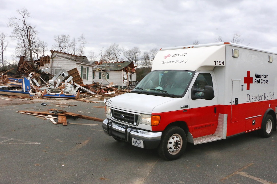 Soldiers help local emergency and first responders while clearing debris around houses in a community in Essex County, Va., Feb. 25, 2016. Virginia National Guard photo by Alfred Puryear