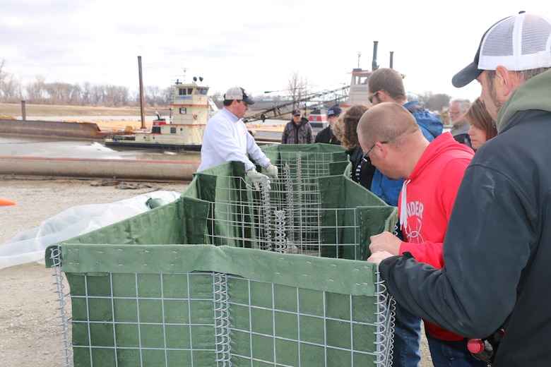 As part of the U.S. Army Corps of Engineers, Omaha District's annual flood fight training program, attendees, learned flood fight measures such as placing and filling HESCO bastions. 