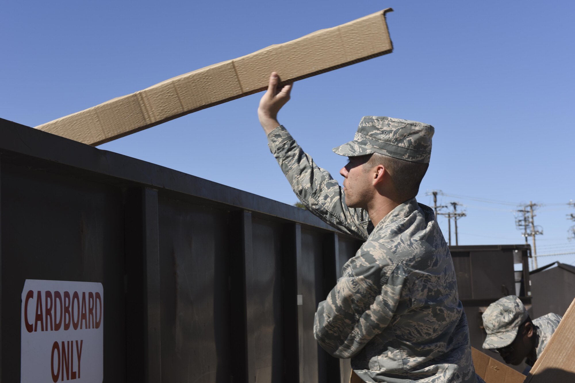 U.S. Air Force Airman Michael Sanchez, 316th Training Squadron student, tosses cardboard into a recycling bin on Goodfellow Air Force Base, Feb. 25, 2016. The cardboard is recycled as part of Goodfellow’s new Integrated Solid Waste Management Contract. (U.S. Air Force photo by Airman Chase Sousa/Released)