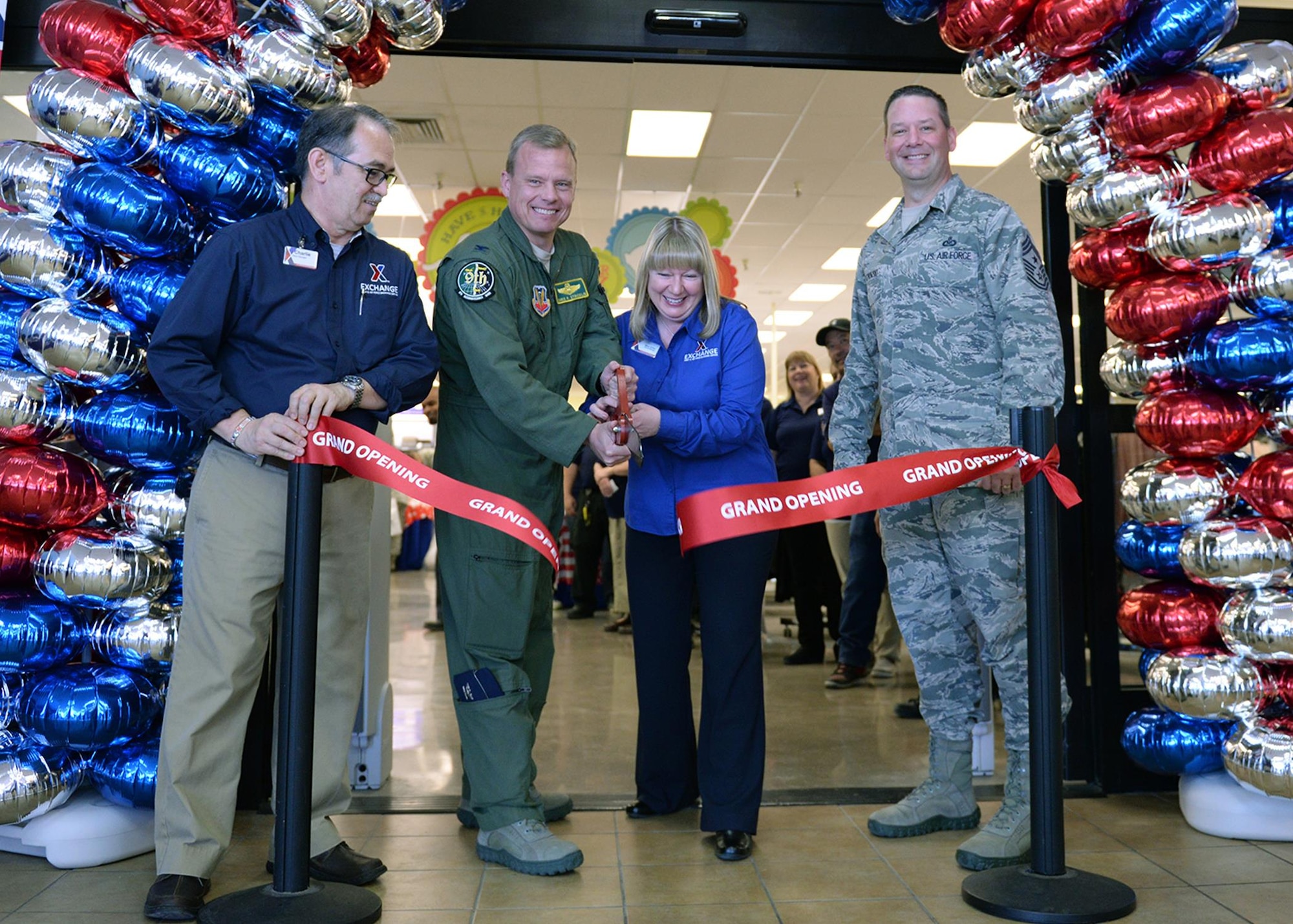 Beale leadership and Exchange management cut the ribbon during the grand re-opening of the newly renovated Base Exchange Feb. 25, 2016, Beale Air Force Base, California. The remodeling project cost approximate$1.9 million, which includes new flooring, a floor plan to accommodate an expanded product line, new displays, and a new central checkout location. (U.S. Air Force photo by Robert Scott)