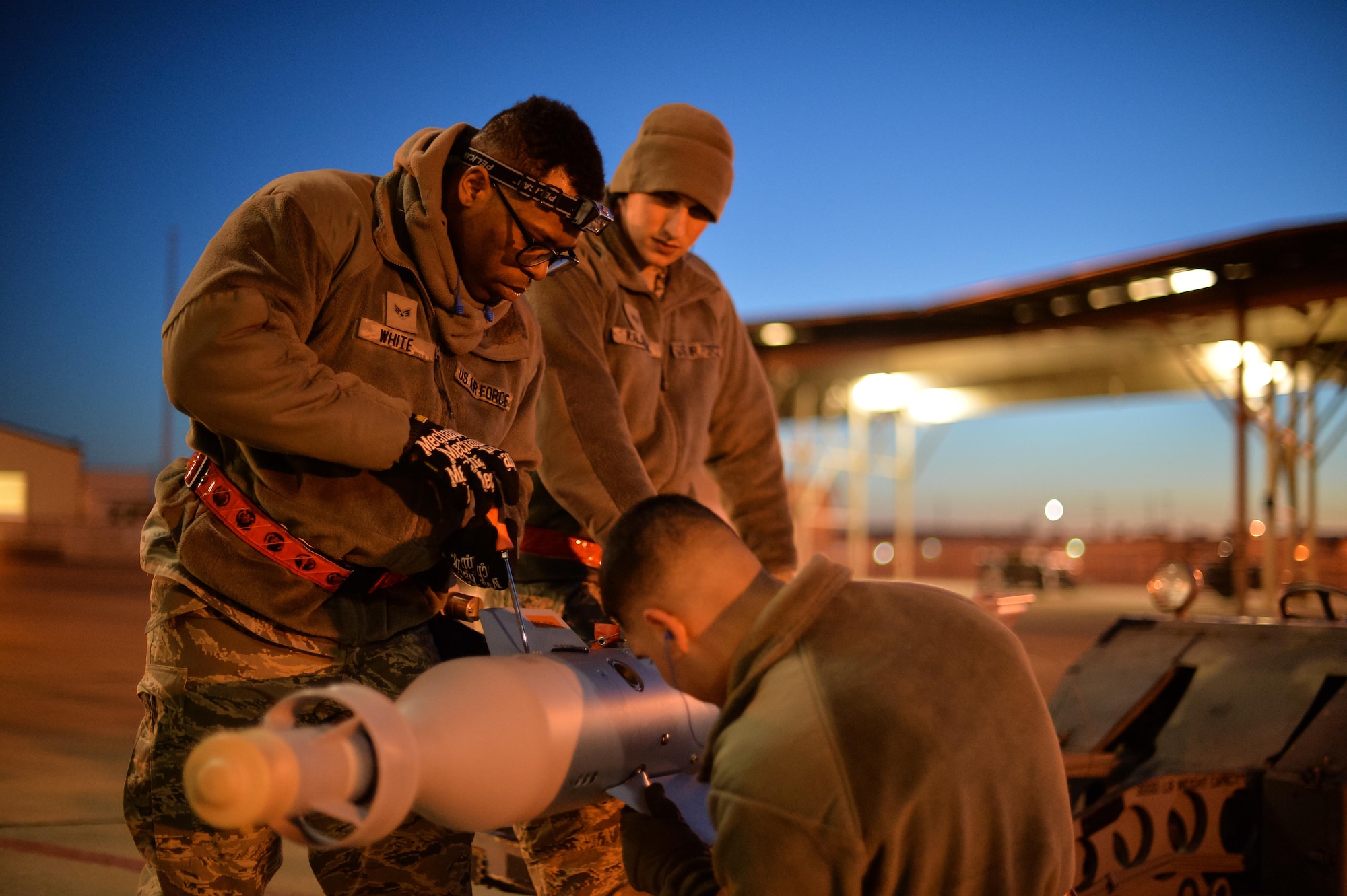 Airman Juan Rivas, Senior Airman Darion White and Staff Sgt. Jeffrey Kalsbeek, 34th Aircraft Maintenance Squadron load crew members, prepare to equip an F-35A with a GBU-12 laser-guided bomb at Hill Air Force Base, Utah, Feb. 23, 2016. (U.S. Air Force photo by R. Nial Bradshaw) 