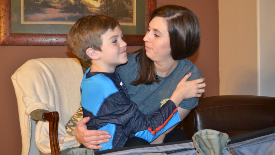 Staff Sgt. Alison Putnam, an Air Force reservist in the 67th Aerial Port Squadron, hugs her 10-year-old son, Carter, as she packs for a six-month deployment. About 80 reservists from the 419th Fighter Wing’s mission support group are currently deployed throughout Southwest Asia. (Courtesy photo)