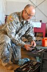 Sgt. Jesse Bankston, a wheeled vehicle mechanic for 103rd Quartermaster Company and Houston, Texas, native, grabs a pair of pliers from his toolbox Feb. 18 at Fort Polk, La. Mechanics of the 103rd Quartermaster Company, an Army Reserve unit from Houston, Texas, and many other units from around the U.S. have been working together during the Joint Readiness Training Centers’ rotation 16-04 operation. The units have come together during the exercise to provide maintenance support for the 4th Brigade Combat Team (Airborne). (U.S. Army Photo by Sgt. Aaron Ellerman 204th Public Affairs Detachment/Released)