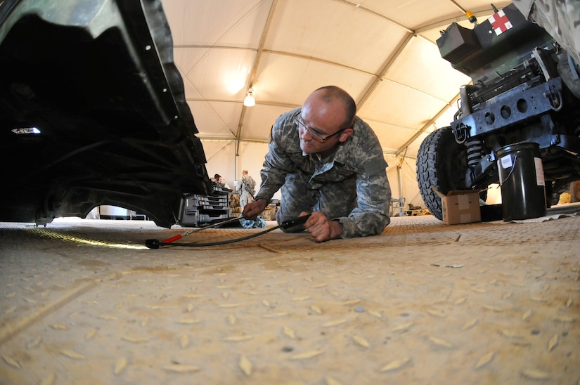 Sgt. Jesse Bankston, a wheeled vehicle mechanic for 103rd Quartermaster Company and a Houston native, inspects the underside of a Humvee hood Feb. 18 at Fort Polk, La. Mechanics of the 103rd Quartermaster Company, an Army Reserve unit from Houston, and many other units from around the U.S. have been working together during the Joint Readiness Training Center's rotation 16-04 operation. The units have come together during the exercise to provide maintenance support for the 4th Brigade Combat Team (Airborne). (U.S. Army Photo by Sgt. Aaron Ellerman 204th Public Affairs Detachment/Released)