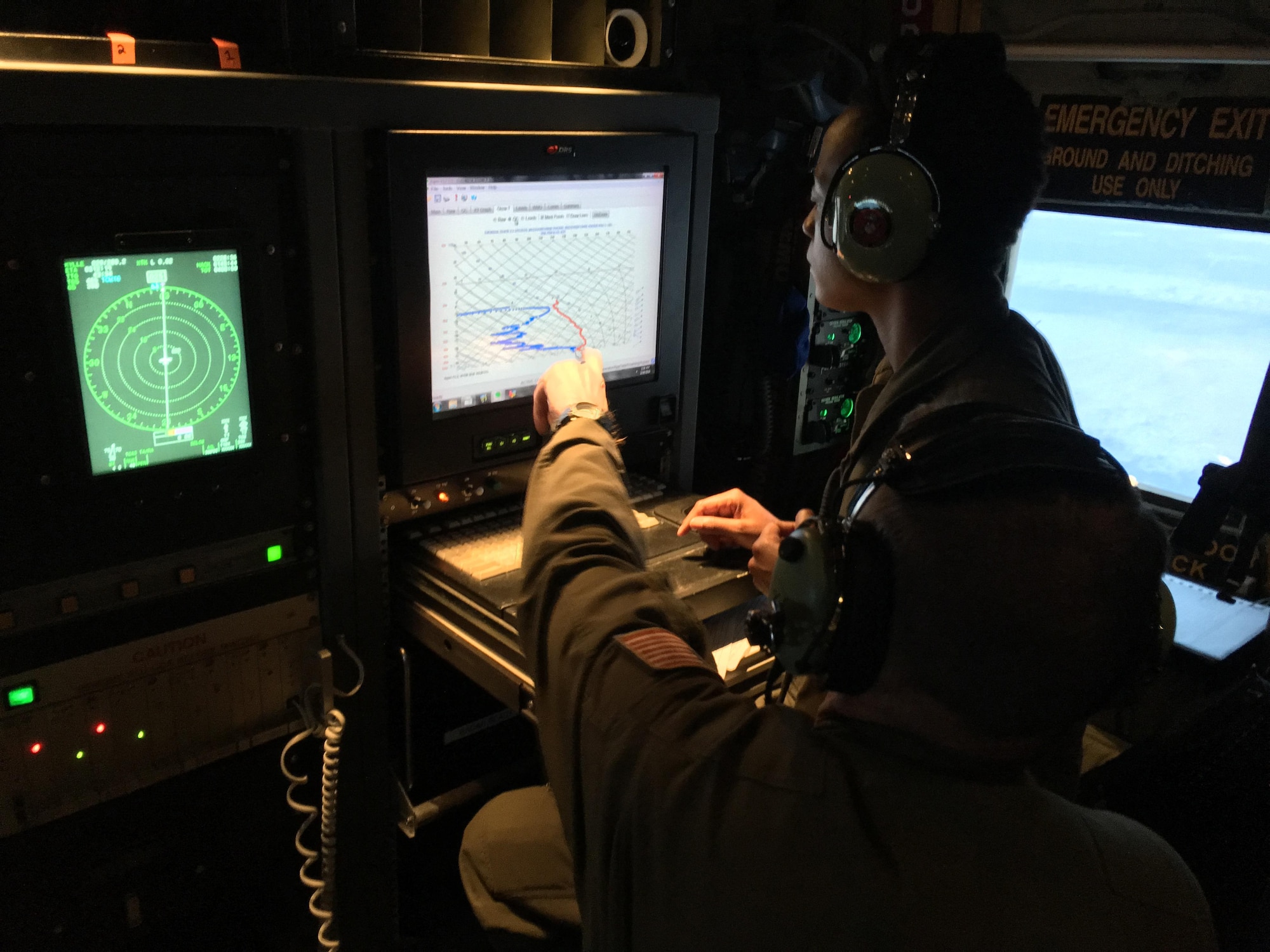 Tech. Sgt. Karen Moore and Chief Master Sgt. Rick Cumbo, 53rd Weather Reconnaissance Squadron loadmasters, analyze weather data being relayed to the aircraft by a dropsonde, a parachute-borne cylindrical instrument that collects meteorological data as it drops toward the surface of the water. The Hurricane Hunters flew several research missions Feb. 11-24, 2016, to collect meteorological data from atmospheric rivers above the Pacific to assist in improving West Coast weather forecasts. (U.S. Air Force photo/Capt. Kimberly Spusta)