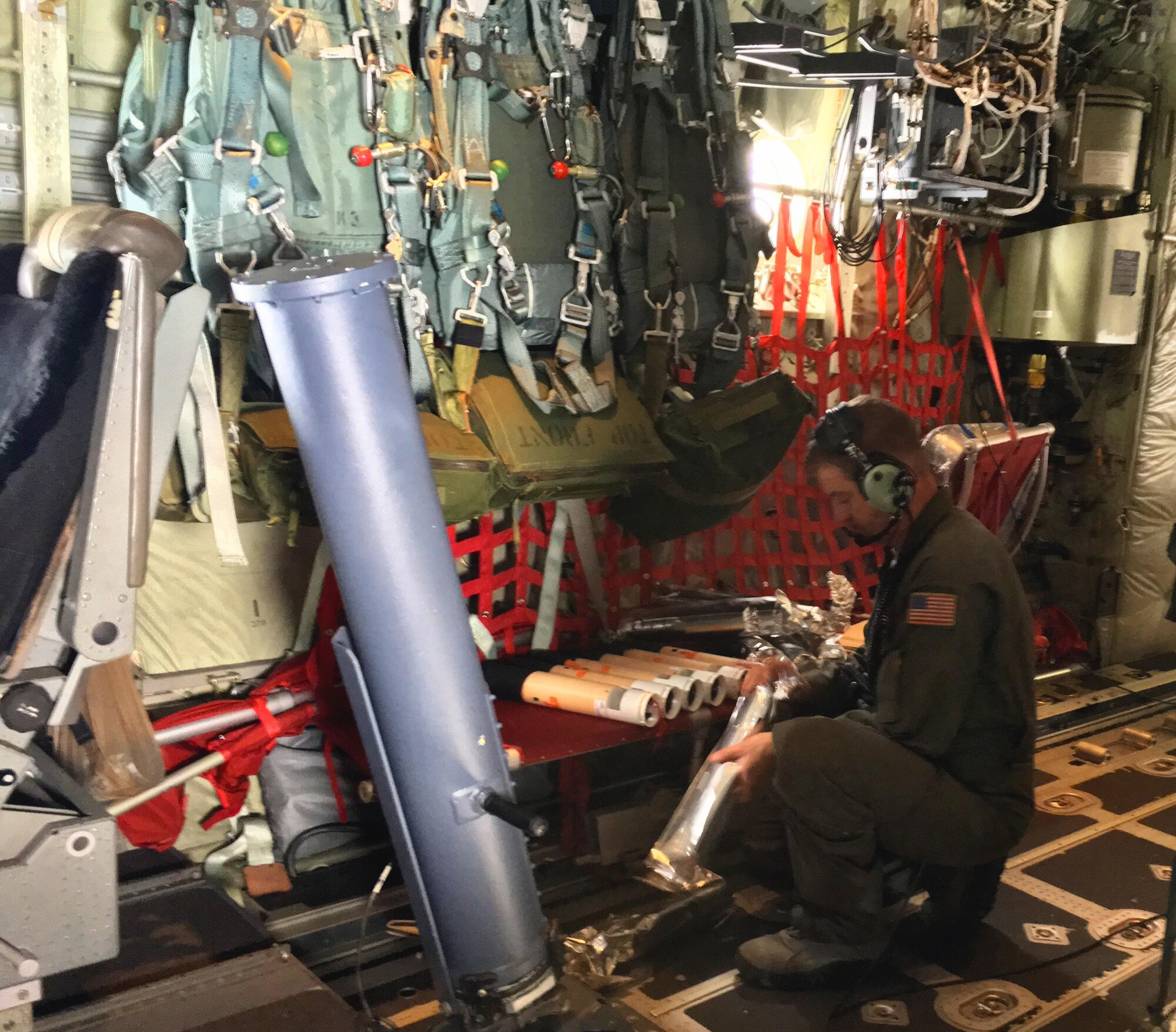 Chief Master Sgt. Rick Cumbo, a 53rd Weather Reconnaissance Squadron chief loadmaster, prepares a dropsonde before placing it into a launch tube as part of a research mission Feb. 11-24, 2016, to collect data from atmospheric rivers over the Pacific to improve West Coast weather forecasts. The Hurricane Hunters use a dropsonde, which is a parachute-borne cylindrical instrument that collects meteorological data as it descends. (U.S. Air Force photo/Capt. Kimberly Spusta)
