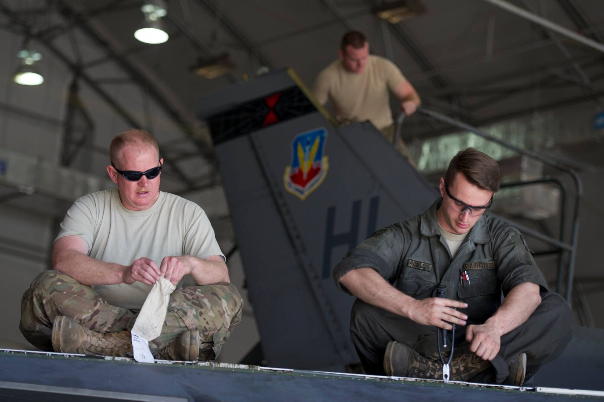 Tech. Sgt. Andrew Harper (left), a deployed reservist from the 419th Fighter Wing, and Senior Airman Joseph Lonneman, from the 388th Fighter Wing, work to remove a leading edge flap on the wing of an F-16 Fighting Falcon assigned to the 421st Expeditionary Fighter Squadron at Bagram Airfield, Afghanistan, Feb. 24. (U.S. Air Force photo/Tech. Sgt. Robert Cloys) 